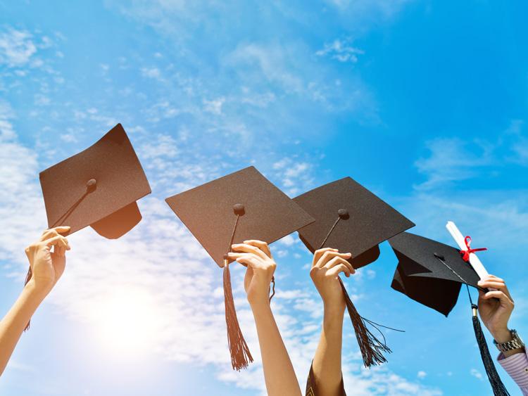 Graduates holding mortar boards