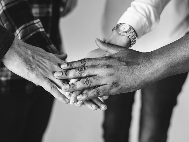 Diverse hands illustrating inclusive student-staff partnership concept