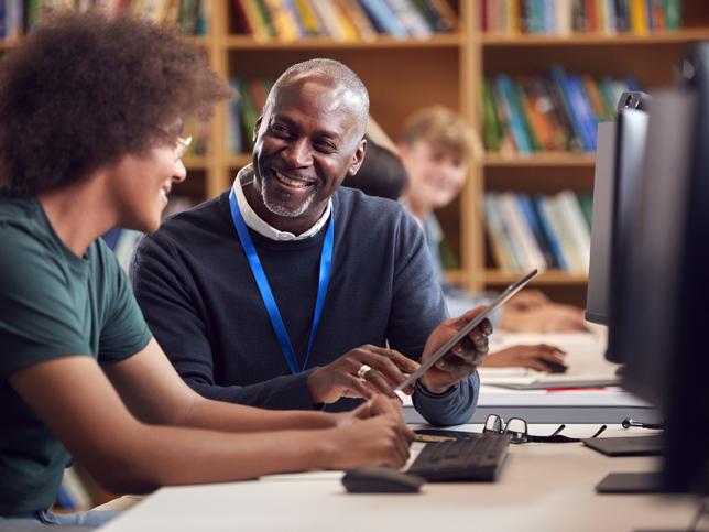 Student and tutor in front of computer