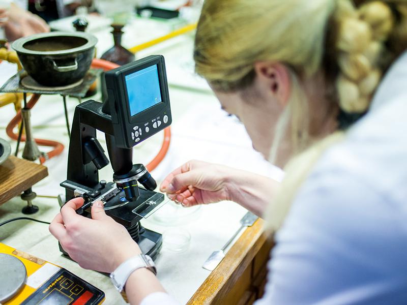 Female medical student examining slide