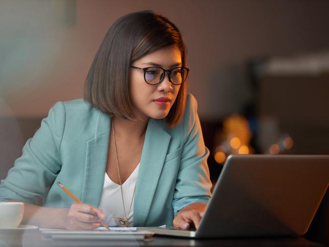 Asian woman working at laptop computer