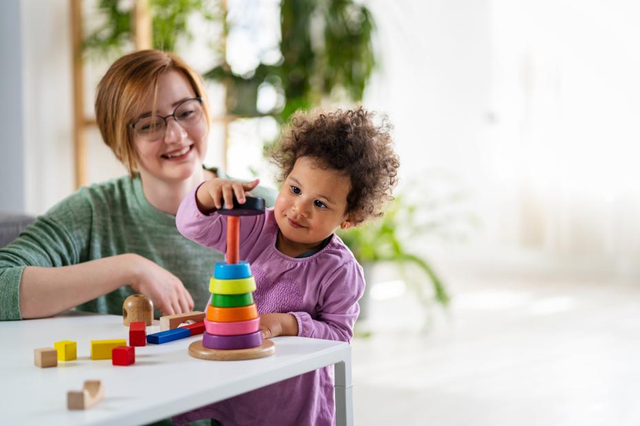 A woman looking after her toddler