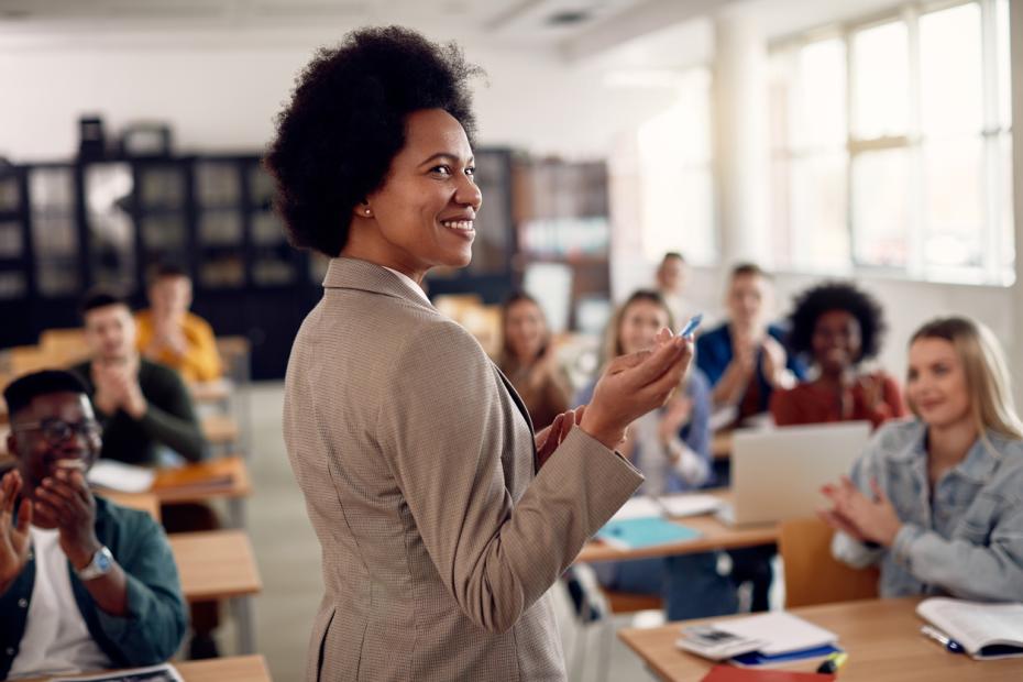 A Black woman lecturer speaks to a university class