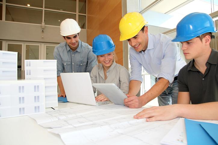 Three architecture students and an instructor work on a project