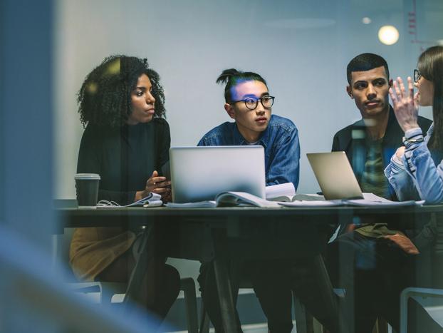 Group of four multiracial young people in a meeting