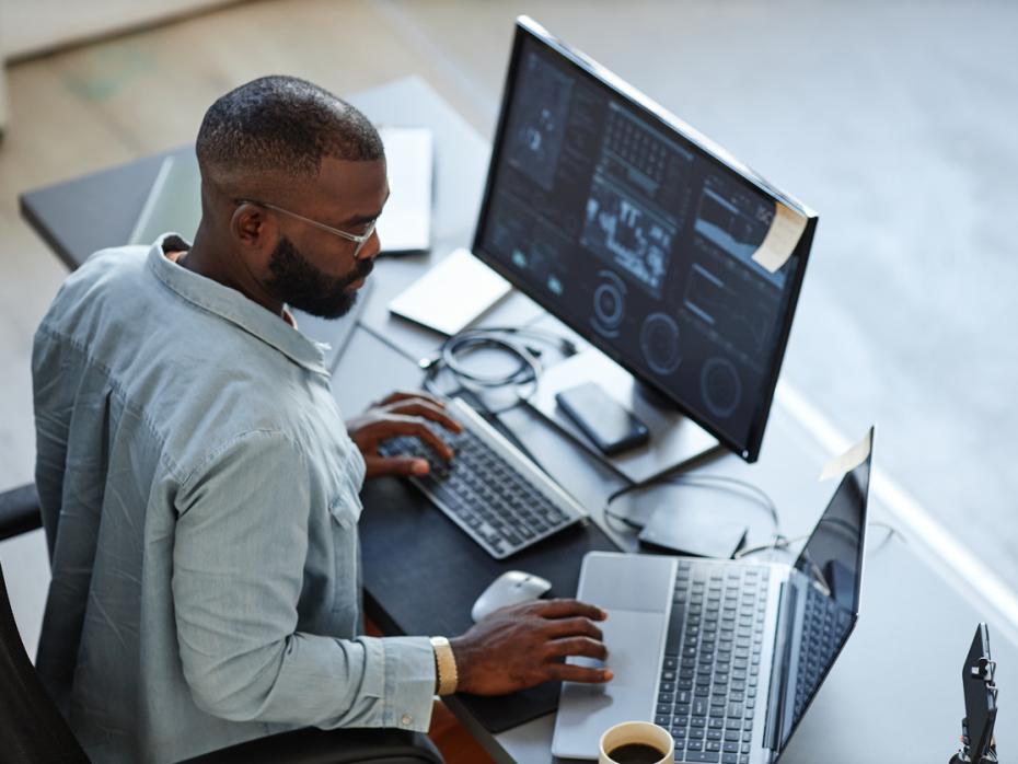 A young man at a computer analysing data