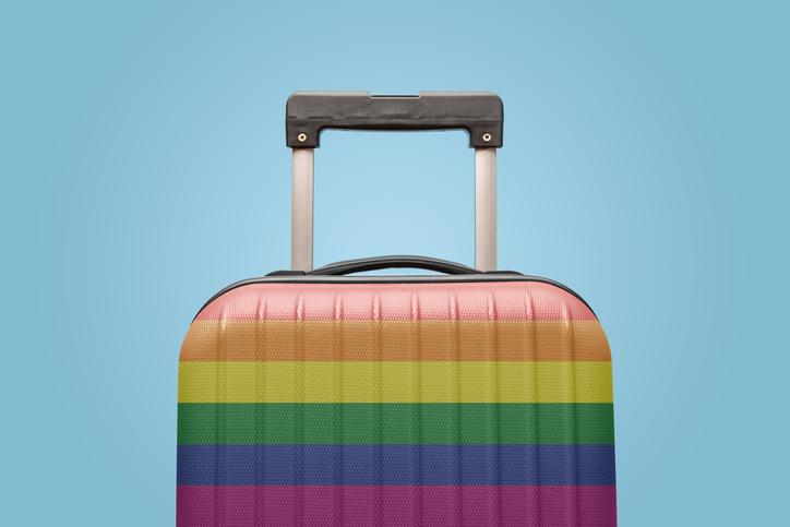 A suitcase decorated in rainbow stripes