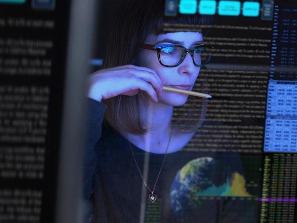 Young woman looking at data on a screen