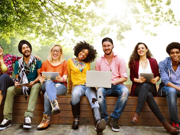 multiracial university students sitting outside