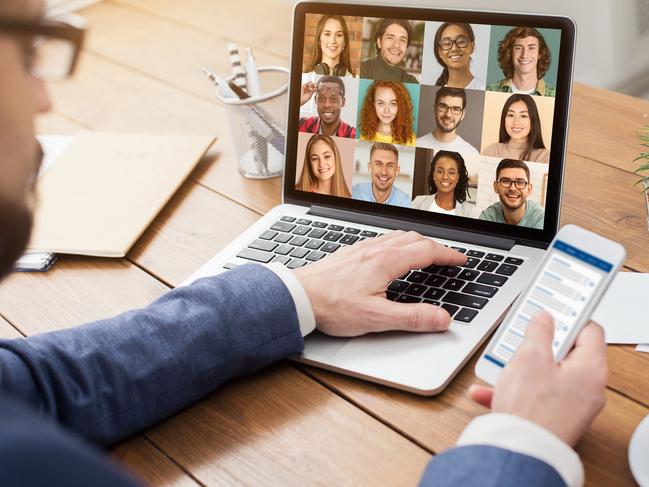 A laptop displays a lively Zoom call