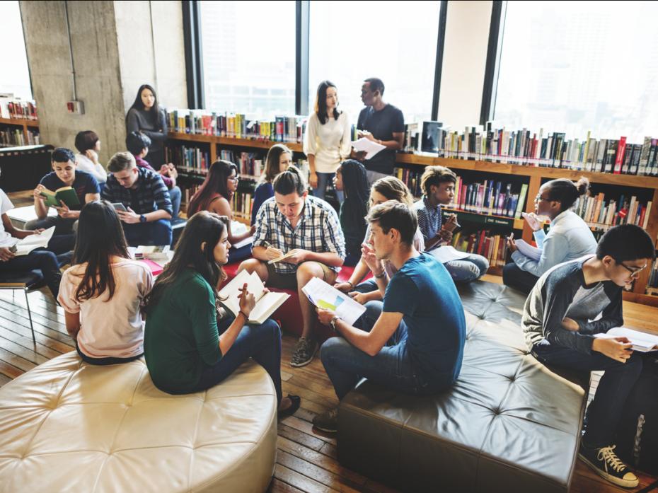 A group of students chatting in a study area