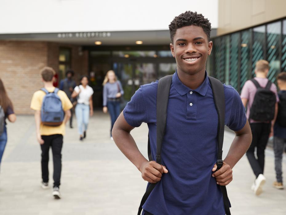 Student standing outside a campus building 