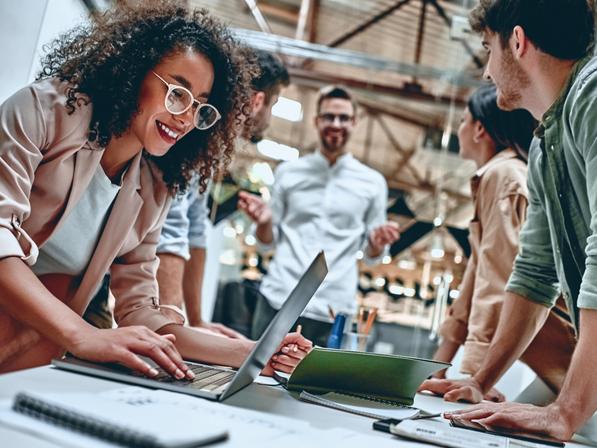 Young people work on laptops