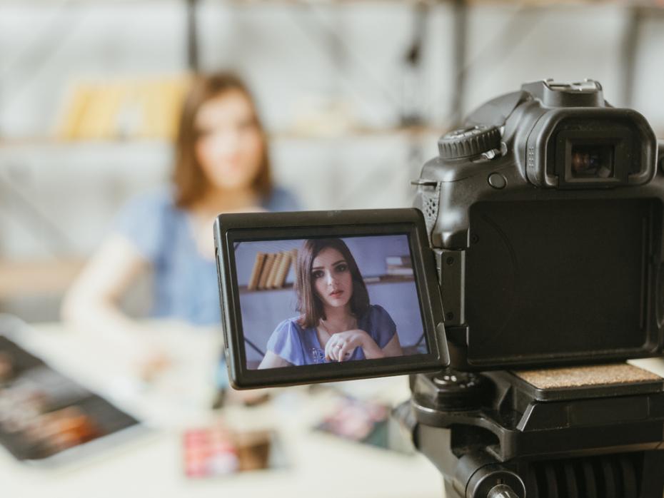 A filming set up of a female student speaking to camera