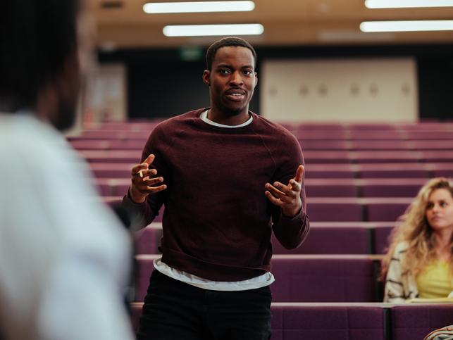 A young student stands up to make a point