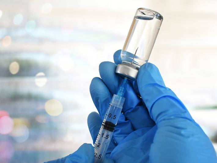 Detail of medic drawing a vaccination shot