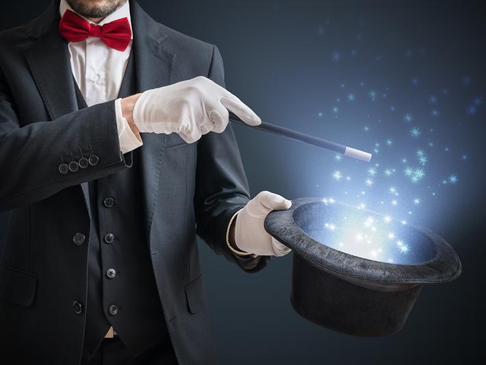 Magician conjuring magic out of a hat