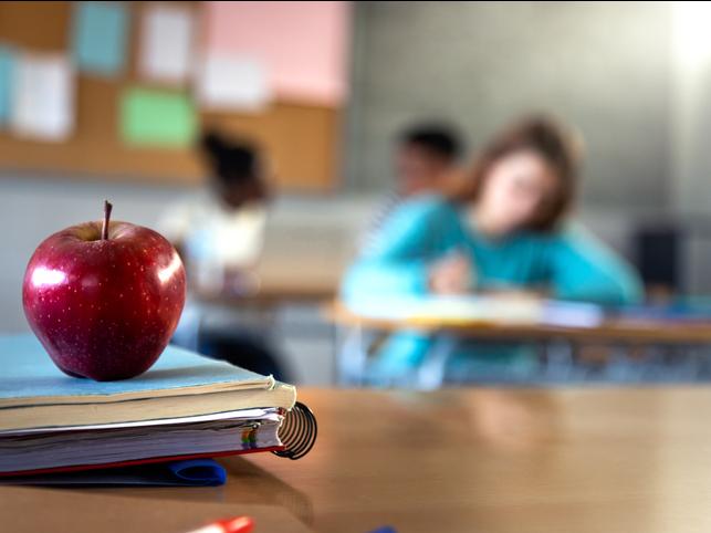 An apple on a classroom desk