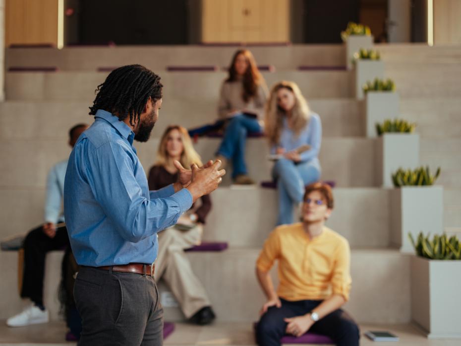 An AI expert presenting in front of room full of staff