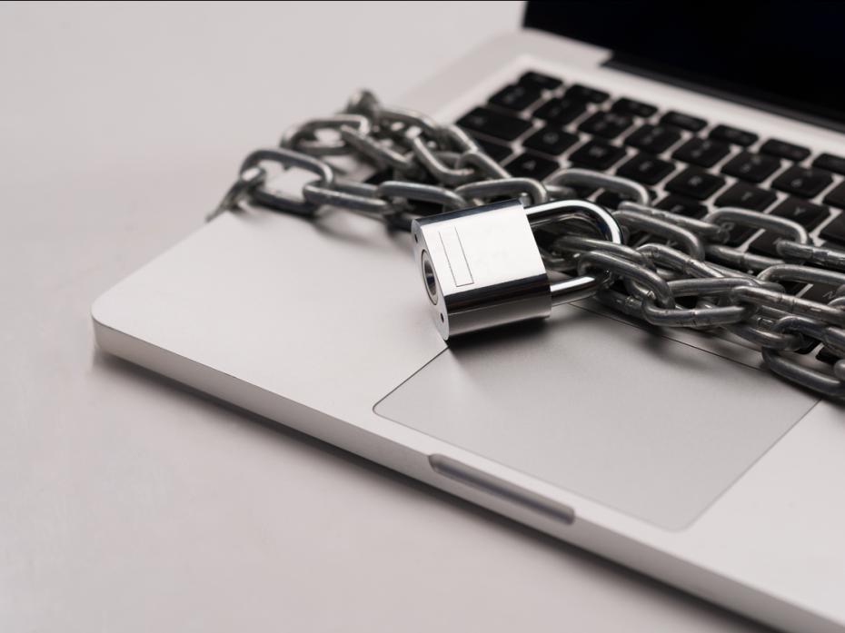 A laptop with a padlocked chain around it
