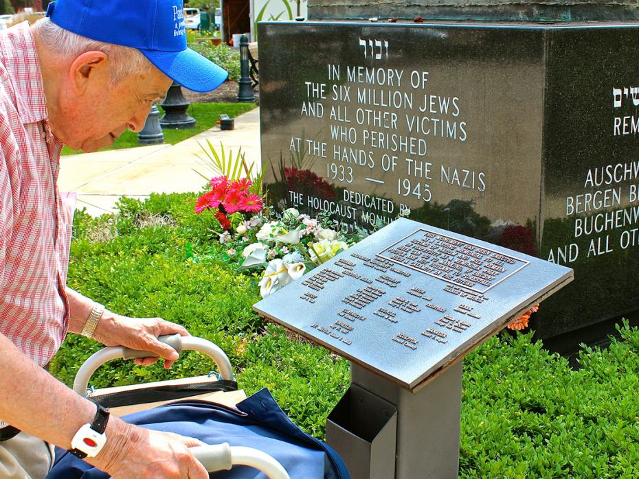 92 year-old Jewish Holocaust survivor, Larry Heimlich of Chicago, reading a dedication plaque at a Holocaust Monument