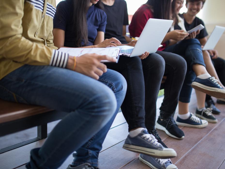 Students looking at various online devices
