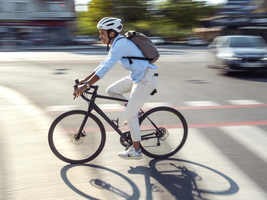 A cyclist riding down a quiet city road