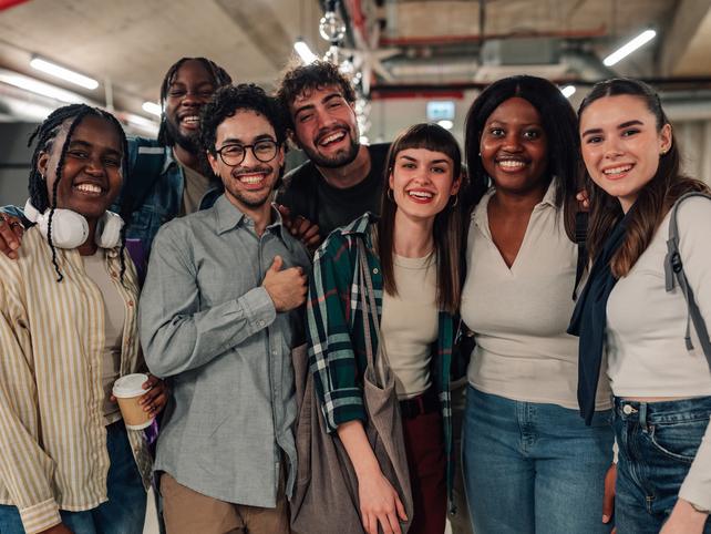 Students laugh in a group together