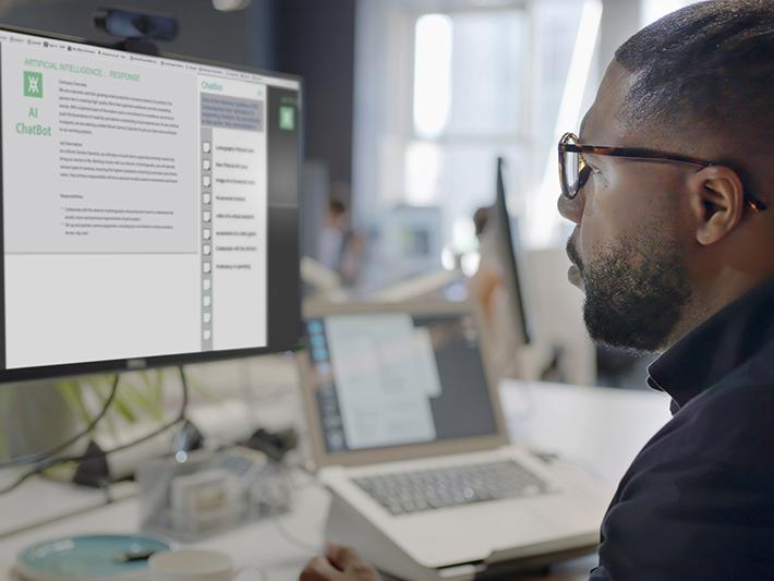 Black man working at computer using AI chatbot