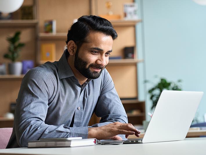 Young indian student using computer remote studying