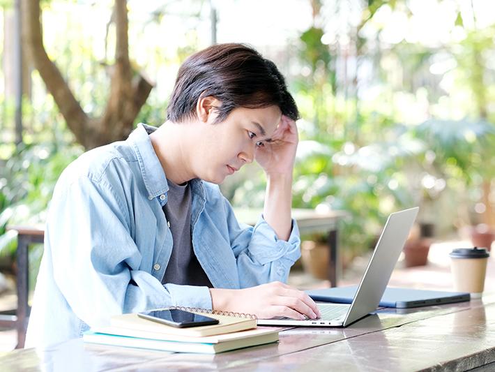 Asian student concentrating at a laptop