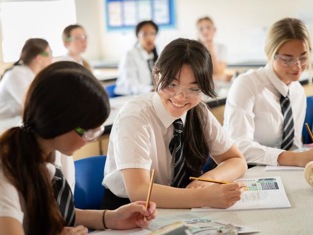 Secondary school pupils studying science in a classroom 