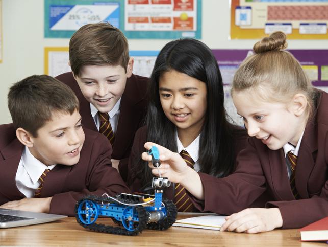 School children building a small robot