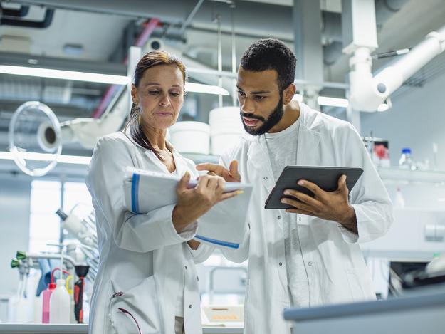 Scientists discuss results in a lab