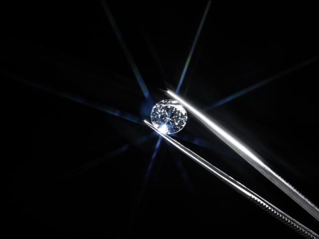 A diamond held by tweezers