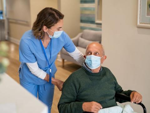 A healthcare professional assisting a male patient