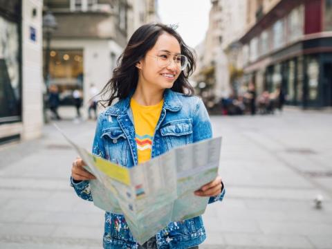 Student exploring a city using a map