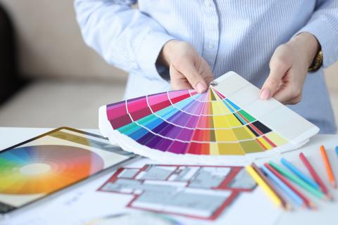 Woman's hands holding a fan colour palette