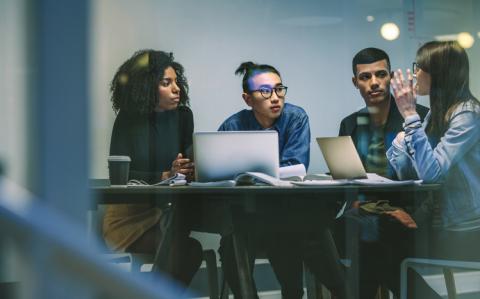 Group of four multiracial young people in a meeting