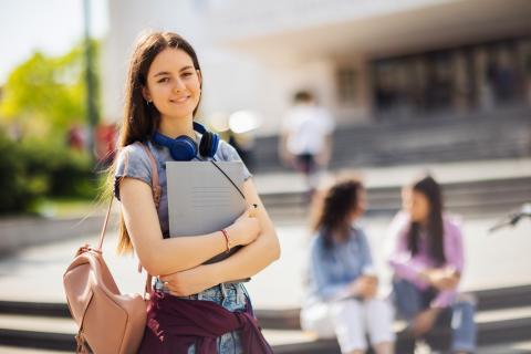 Student standing outside a university building