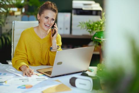 Female accountant sitting at her desk making a phone call