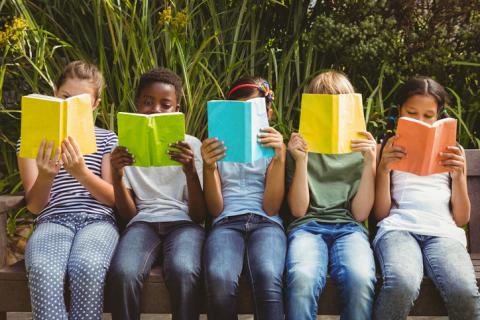 Row of children reading colourful books