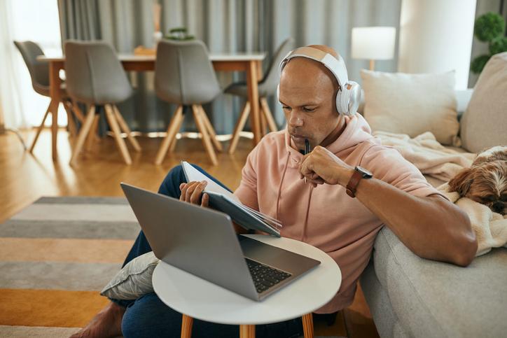 Young black man studying at home on laptop