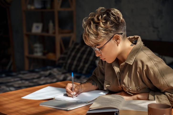 Young female student writing at a desk