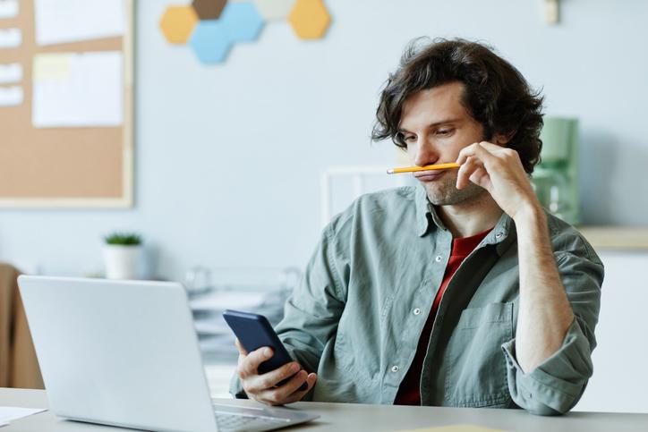 Man procrastinating at laptop