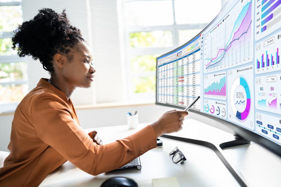 Student analysing graphs and data sets on a large screen