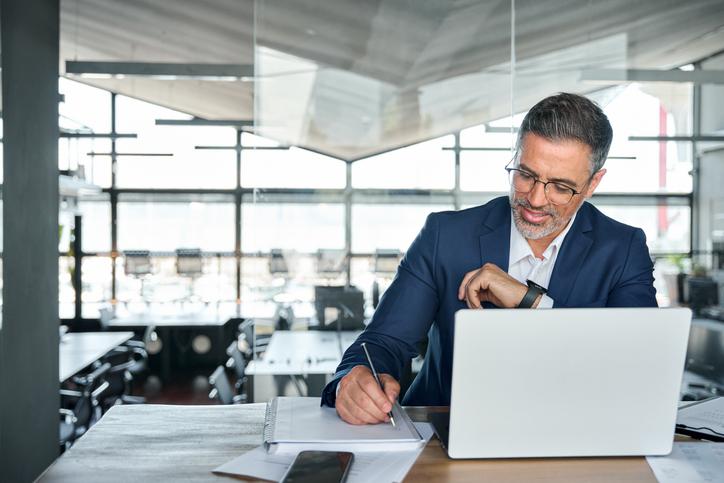 A businessman works at a laptop