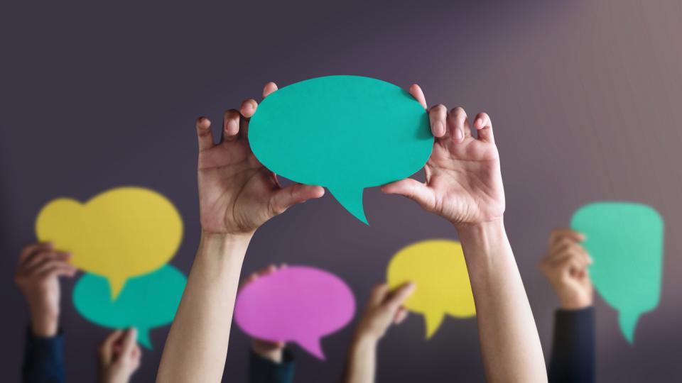 Speech bubbles being held above unseen person's head
