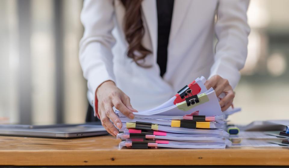A teacher going through a pile of papers