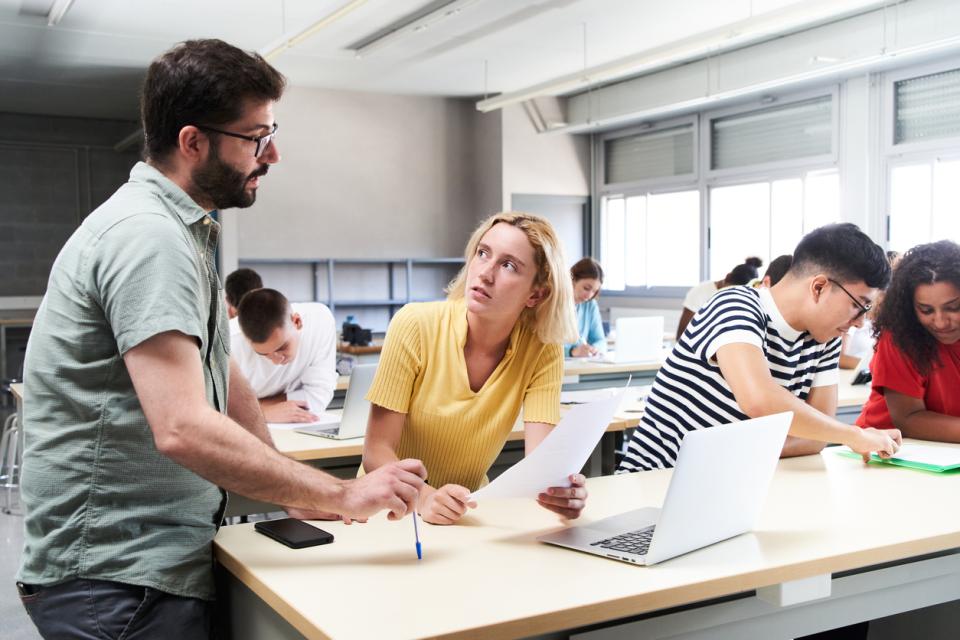 A student speaking to a teacher in class